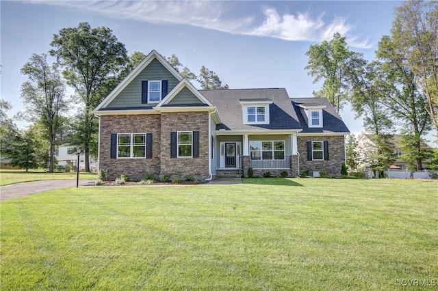 craftsman house featuring a front lawn and covered porch