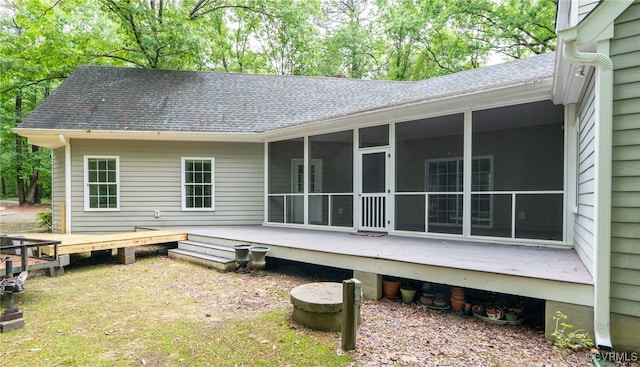 back of house featuring a sunroom and a deck