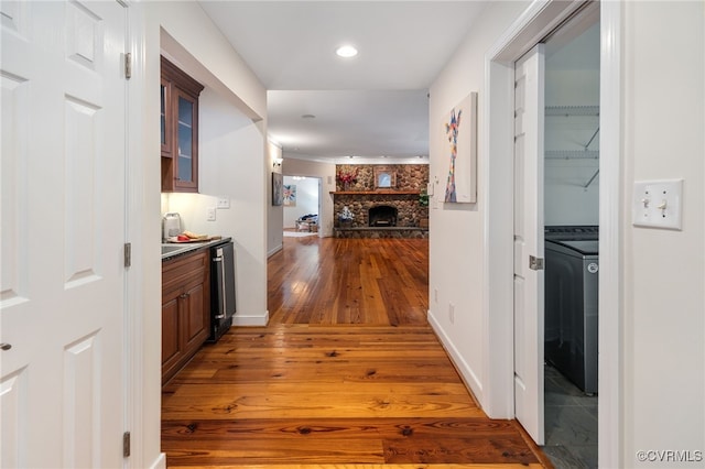 corridor featuring dark hardwood / wood-style floors and washer / dryer