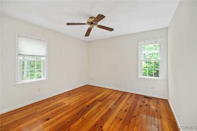 spare room with ceiling fan and wood-type flooring