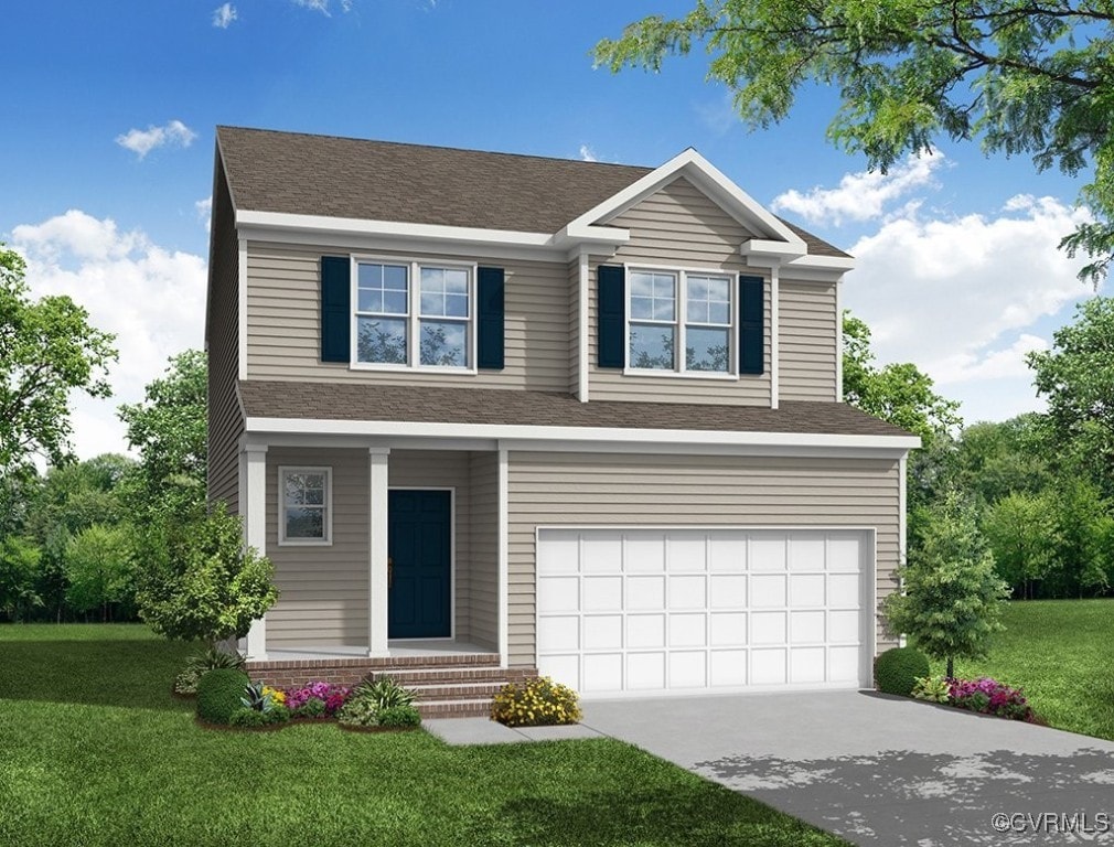 view of front of property with a front yard and a garage