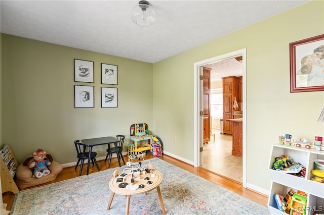 sitting room with a textured ceiling and hardwood / wood-style floors