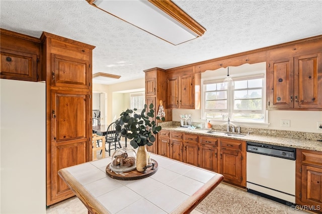 kitchen with tile countertops, sink, light tile patterned floors, a textured ceiling, and white appliances