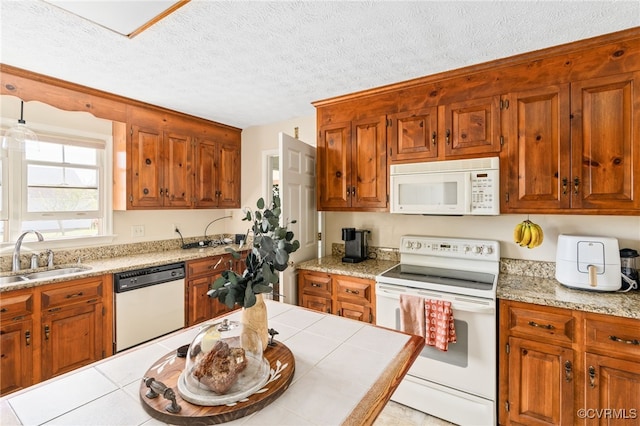 kitchen with a textured ceiling, sink, light tile patterned floors, and white appliances