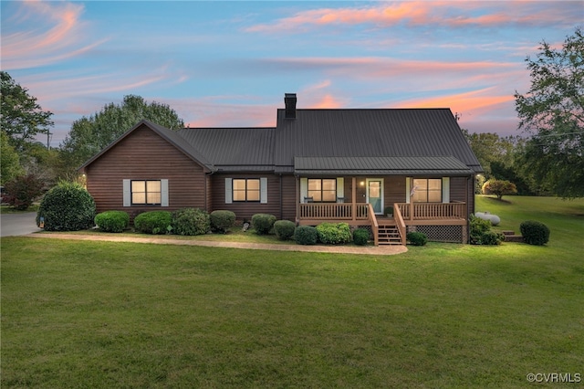 view of front of home featuring a yard and covered porch