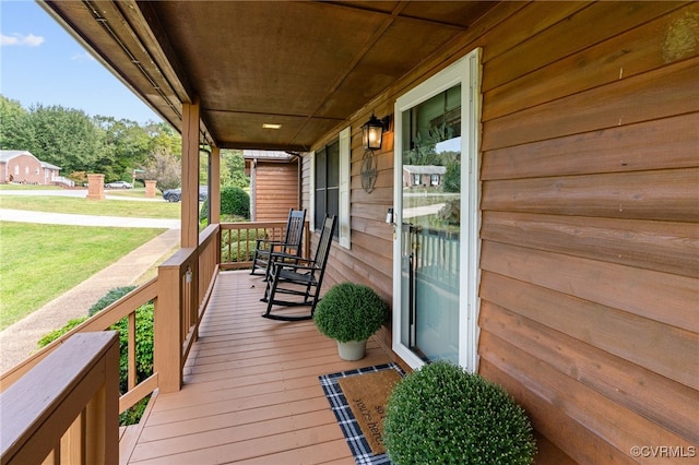 deck featuring a porch and a lawn