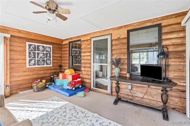 interior space with ceiling fan