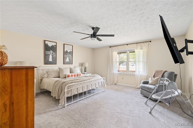 carpeted bedroom with a textured ceiling and ceiling fan