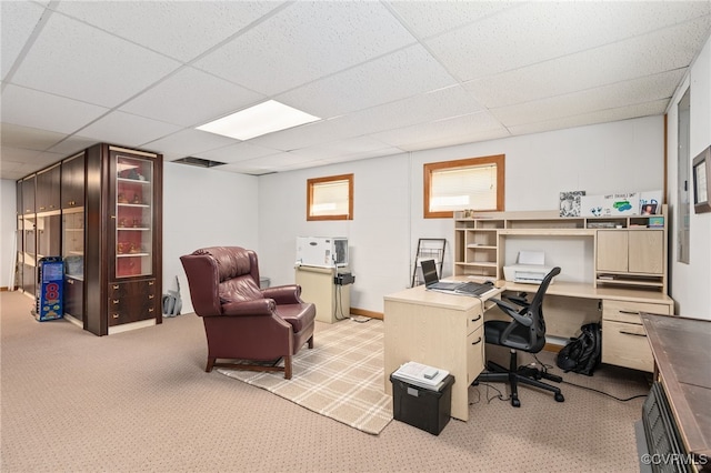 carpeted home office featuring a drop ceiling