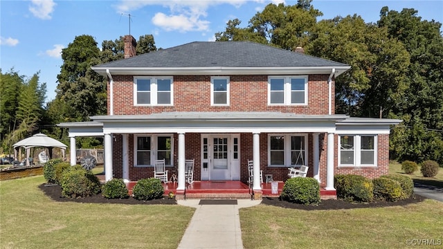 view of front facade featuring a porch, a front lawn, and a gazebo