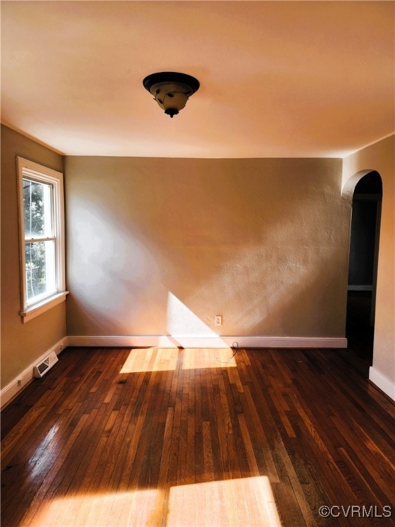 unfurnished room featuring dark hardwood / wood-style floors