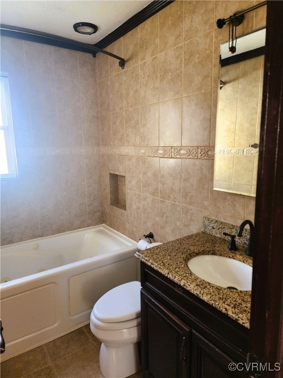 full bathroom featuring tile patterned flooring, toilet, crown molding, tiled shower / bath, and vanity