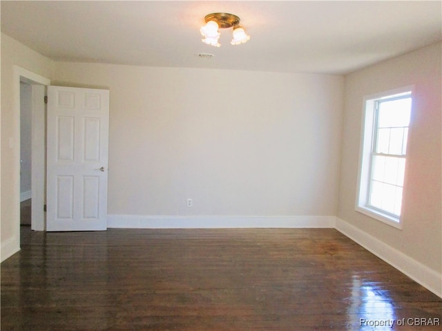 unfurnished room featuring dark hardwood / wood-style floors