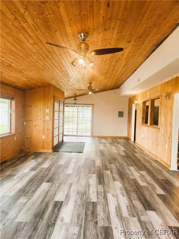 interior space featuring wood walls, ceiling fan, wooden ceiling, lofted ceiling, and hardwood / wood-style flooring