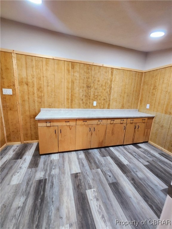 interior space featuring wood walls and light hardwood / wood-style flooring