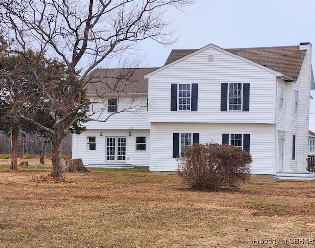 back of property featuring a yard