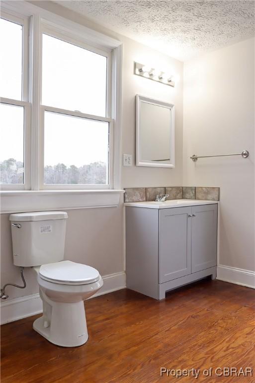 1934 Farley Park Rd, Middlesex, VA 23032 - half bath featuring baseboards, vanity, toilet, wood finished floors, and a textured ceiling