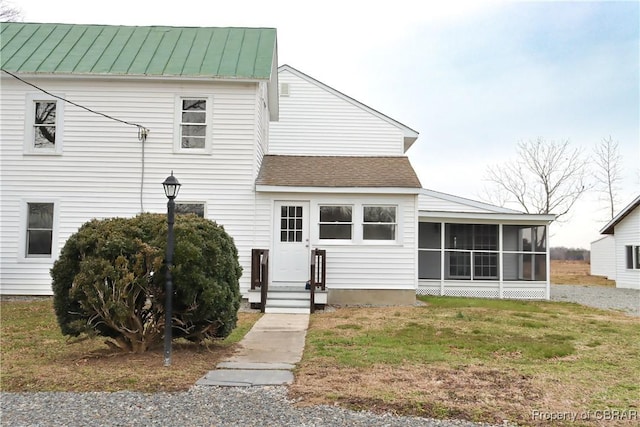 1934 Farley Park Rd, Middlesex, VA 23032 - rear view of property featuring a sunroom, a standing seam roof, a lawn, metal roof, and roof with shingles