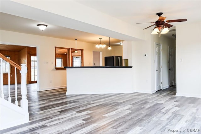 1934 Farley Park Rd, Middlesex, VA 23032 - unfurnished living room featuring wood finished floors, stairs, baseboards, and a ceiling fan