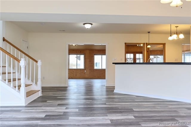 1934 Farley Park Rd, Middlesex, VA 23032 - unfurnished living room featuring wood finished floors, baseboards, stairs, and a chandelier