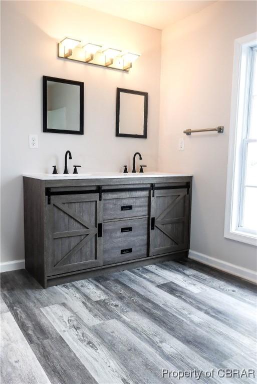 1934 Farley Park Rd, Middlesex, VA 23032 - bathroom with double vanity, baseboards, and wood finished floors