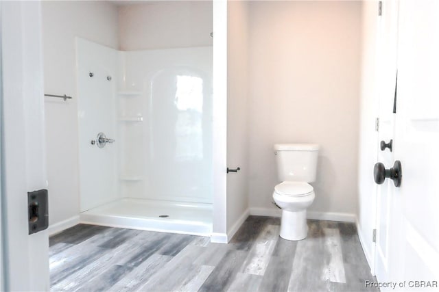 1934 Farley Park Rd, Middlesex, VA 23032 - bathroom featuring toilet, wood finished floors, a shower, and baseboards