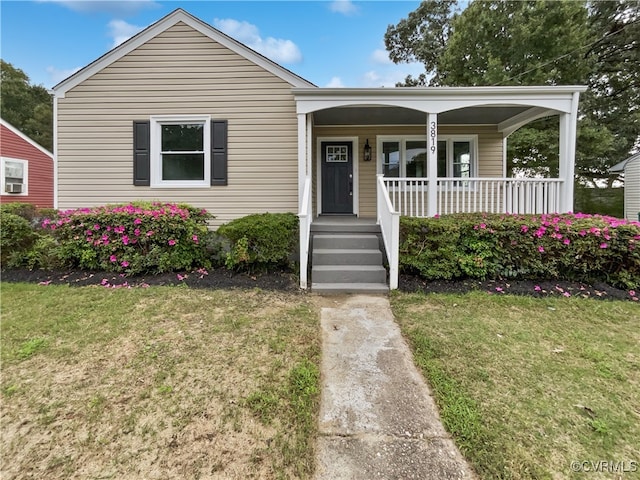 bungalow with a front lawn and a porch