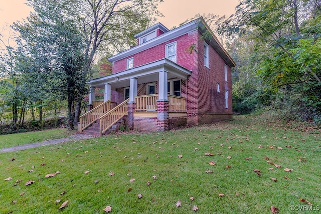 view of front of home featuring a yard and covered porch