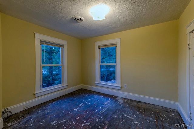 spare room with a textured ceiling