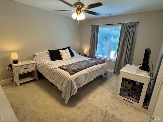 bedroom with light carpet, baseboards, visible vents, and ceiling fan