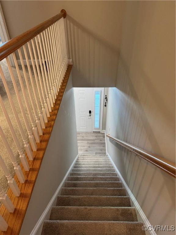 staircase featuring baseboards