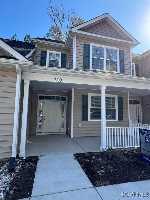 view of exterior entry with a porch