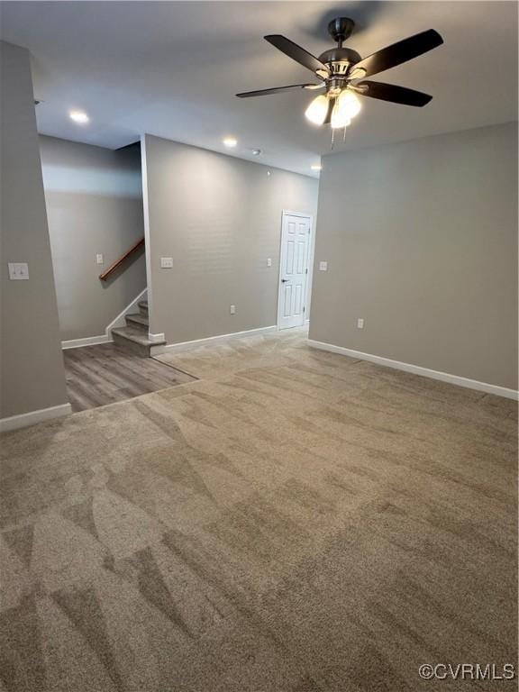 carpeted empty room featuring ceiling fan