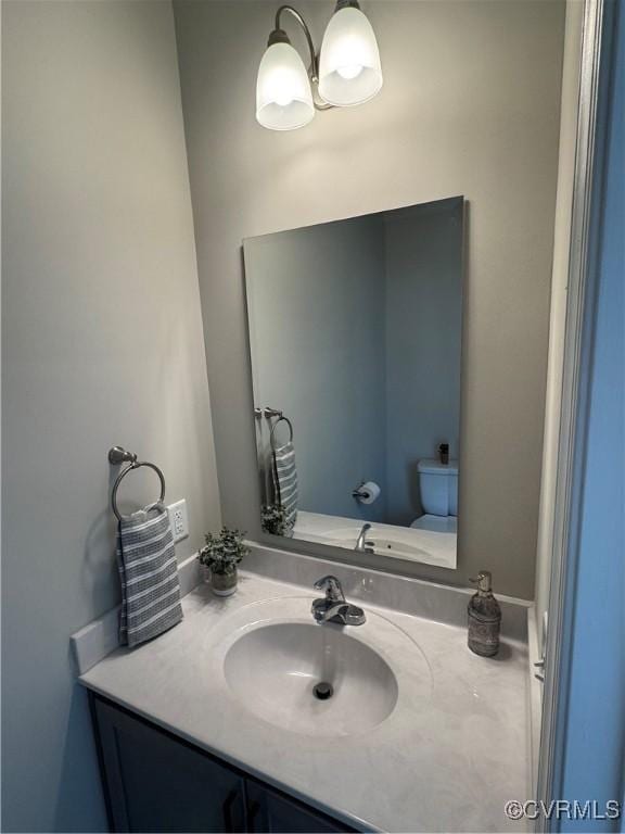 bathroom featuring vanity and toilet