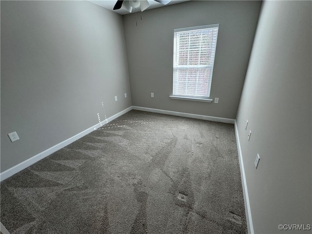 spare room featuring ceiling fan, carpet flooring, and baseboards