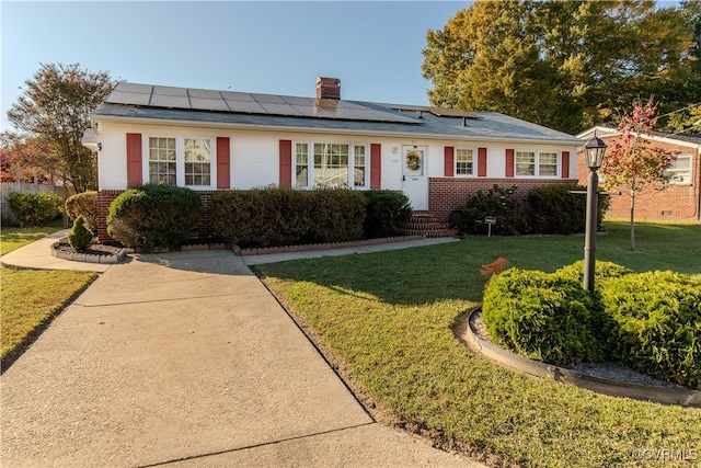 ranch-style house featuring solar panels and a front lawn