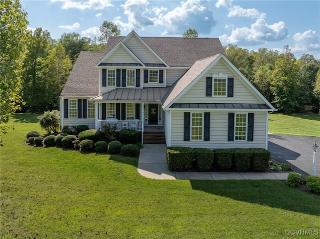 view of front of house with a porch and a front lawn