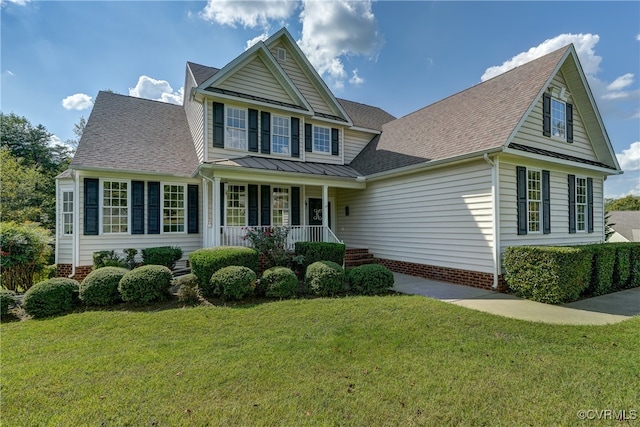 view of property with covered porch and a front yard