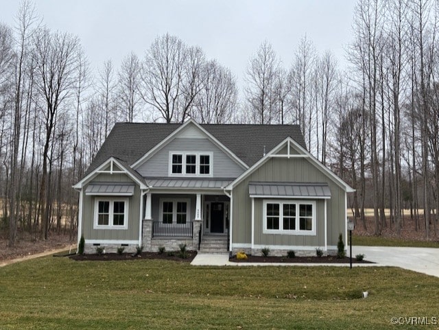 craftsman inspired home featuring a front yard, a standing seam roof, covered porch, crawl space, and board and batten siding