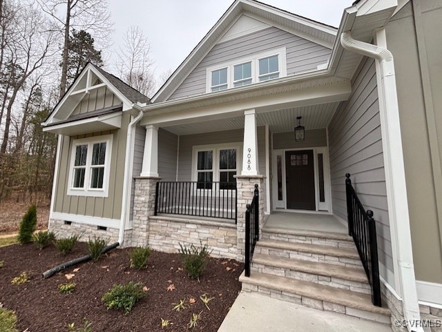 view of front of house with covered porch, board and batten siding, and crawl space