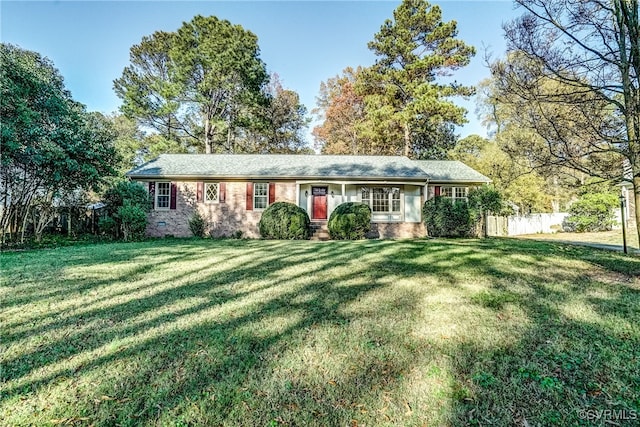 ranch-style home featuring a front yard