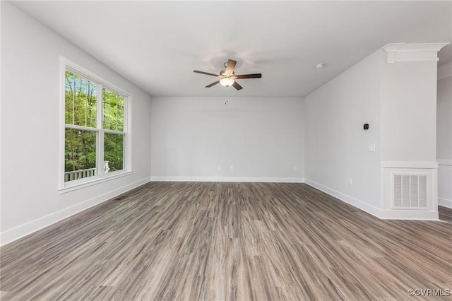 spare room with hardwood / wood-style flooring and ceiling fan