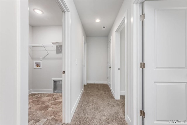 corridor featuring light colored carpet