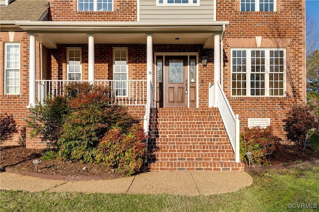 view of exterior entry with a porch