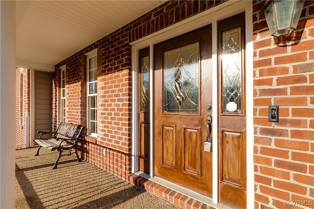 view of exterior entry with covered porch