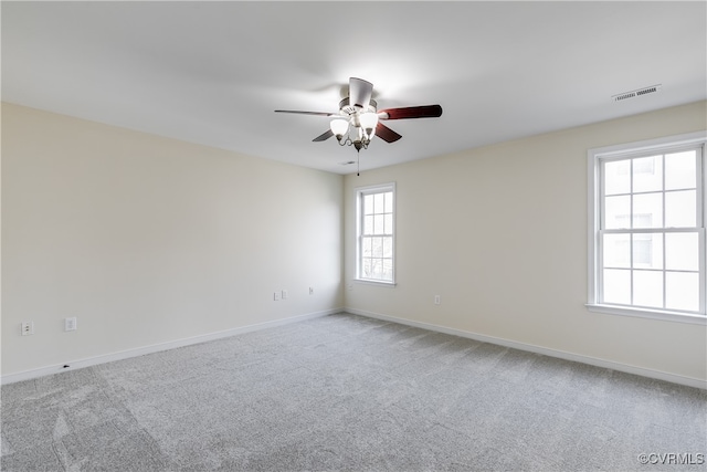 carpeted empty room featuring ceiling fan