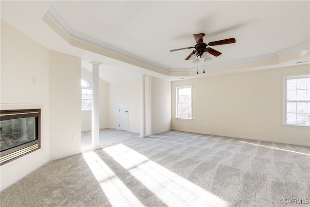 carpeted empty room featuring a raised ceiling and crown molding