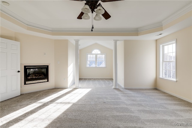 unfurnished living room featuring ornate columns, plenty of natural light, light colored carpet, and ornamental molding