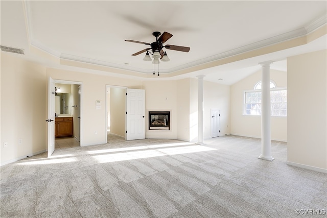 unfurnished living room with a raised ceiling, light carpet, crown molding, and ceiling fan