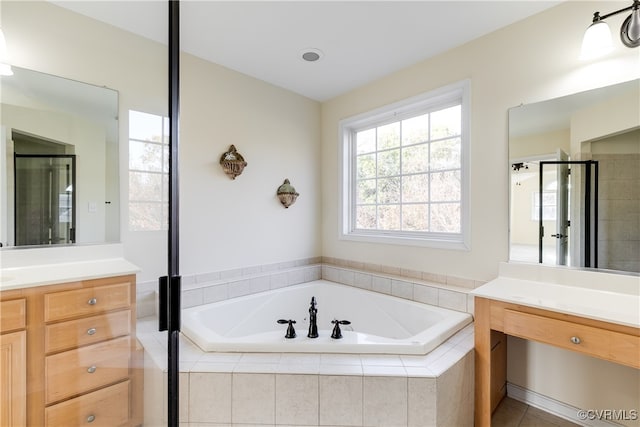 bathroom featuring tile patterned flooring, vanity, and plus walk in shower